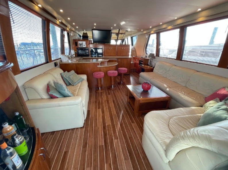 Main salon of the 65ft Carver yacht with leather seating and wood floors