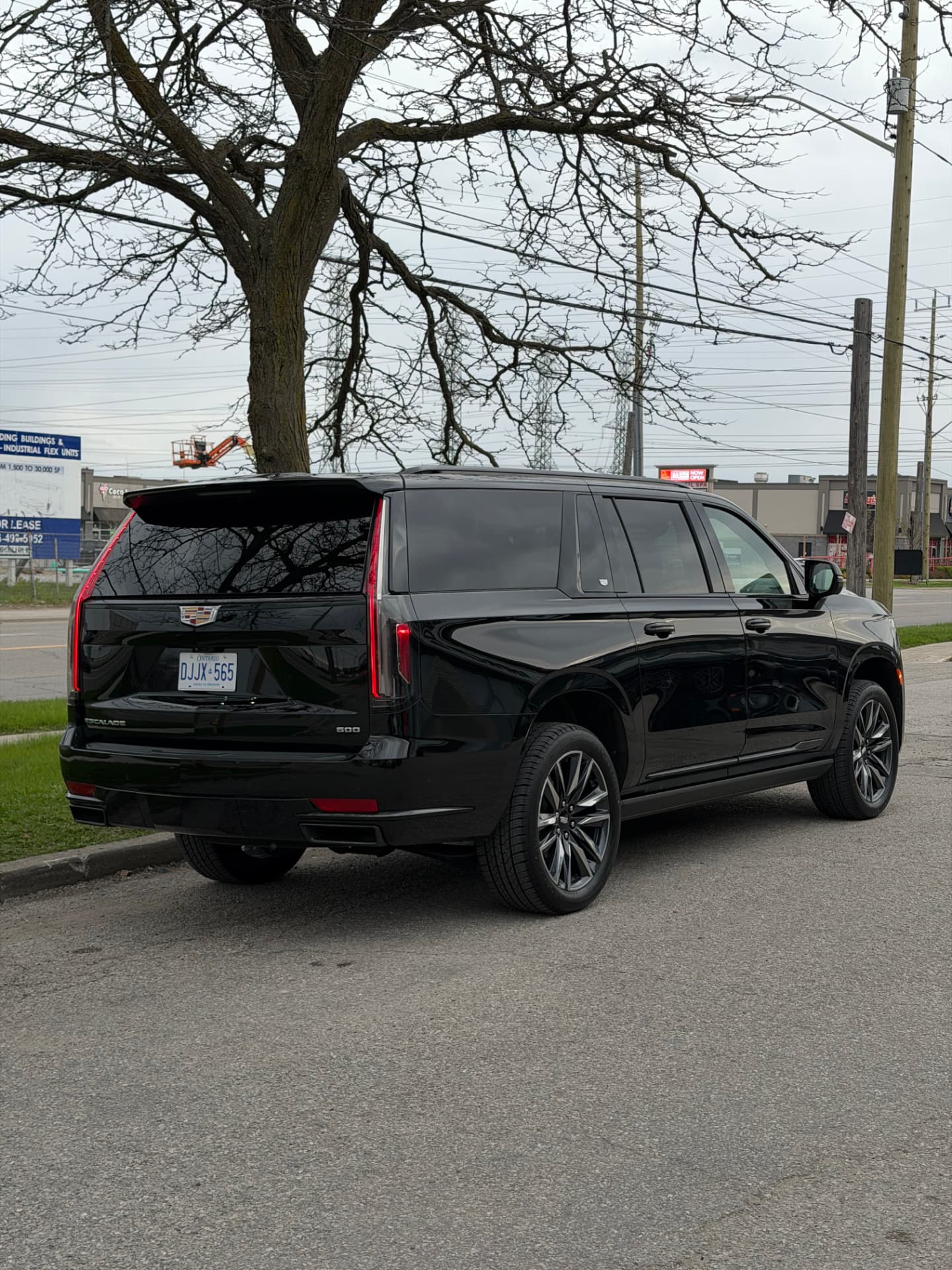 Black Cadillac Escalade ESV rear three-quarter view